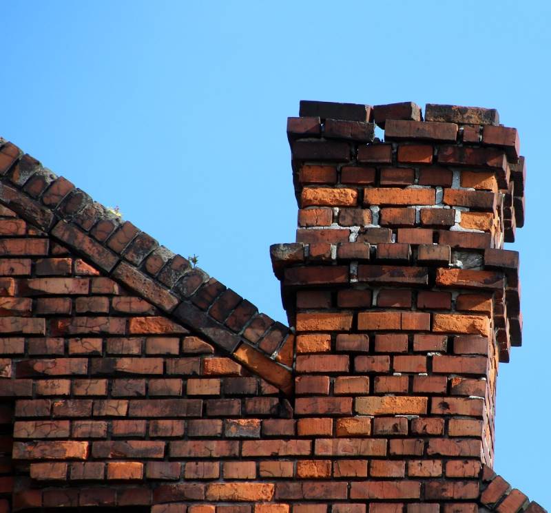 Damaged chimney on an Brooklyn Park home showing cracks and missing mortar